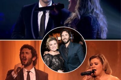 Under the glow of the stage lights, Josh Groban and Kelly Clarkson stood side by side, their voices intertwining like a dance. As the first notes of the timeless classic from Phantom of the Opera filled the air, the room seemed to hold its breath. Groban’s rich, velvety tones soared with a depth that resonated in the hearts of the audience, while Clarkson’s powerful, emotive voice brought the song to life with raw passion. Together, they transformed the iconic melody into something unforgettable, each note a story, each harmony a moment of pure magic.