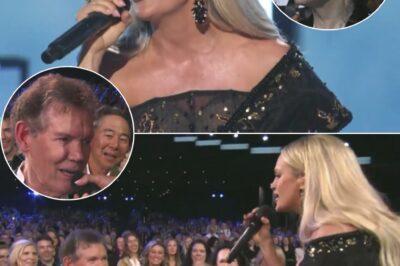 At Opry 100 – A Live Celebration, Carrie Underwood delivered a breathtaking tribute to Randy Travis, moving the entire audience to tears. As she poured her heart into the song, she made the moment even more powerful by handing the mic to Randy Travis, honoring the legend in a way that only she could. The gesture was a poignant reminder of their deep connection, dating back to when he invited her to join the Opry family years ago. Blake Shelton, hosting the historic event, looked on with admiration as the crowd rose to their feet in an emotional standing ovation. Carrie’s performance wasn’t just a tribute—it was a full-circle moment that celebrated the legacy of one of country music’s greatest icons.