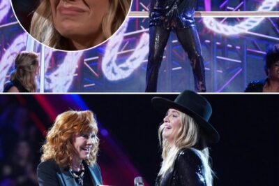 Lainey Wilson lit up the stage with her fiery performance of “Hang Tight Honey” on The Voice season finale, delivering a show-stopping moment that had the audience on their feet. But the real surprise came when Reba McEntire stepped forward, catching Lainey off guard with an emotional invitation to join the Grand Ole Opry. Overwhelmed, Lainey’s eyes filled with tears as Reba’s words sank in, marking a career-defining moment in front of millions.