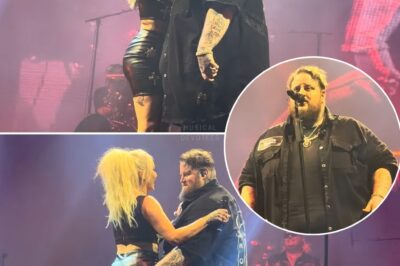 Jelly Roll and his wife, Bunnie XO, turned up the heat in Alpharetta with a soul-stirring performance of “Kill a Man” that left the crowd breathless. The stage became their battlefield of emotions, each lyric charged with raw, unfiltered passion. As the music built to a powerful crescendo, their connection took center stage—locking eyes, embracing, and sharing a kiss that felt like a promise and a story all at once. The audience, swept up in the intensity, rose to their feet, cheering as if they were witnessing something sacred.