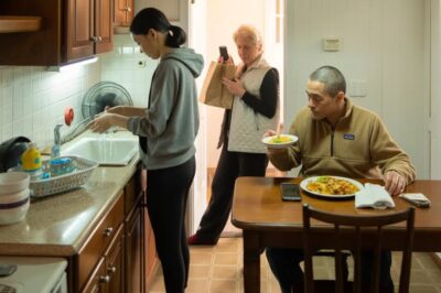 I didn’t even knock—I used my spare key. The house hit me like ice, and there was my daughter at the sink, shaking, while her husband and his mother ate under a space heater like royalty. Then he snapped, “Stop washing—bring more food!” Emily flinched. I felt my throat burn. I raised my phone and whispered, “Not today.” Five minutes later, the knock came… and everything changed.